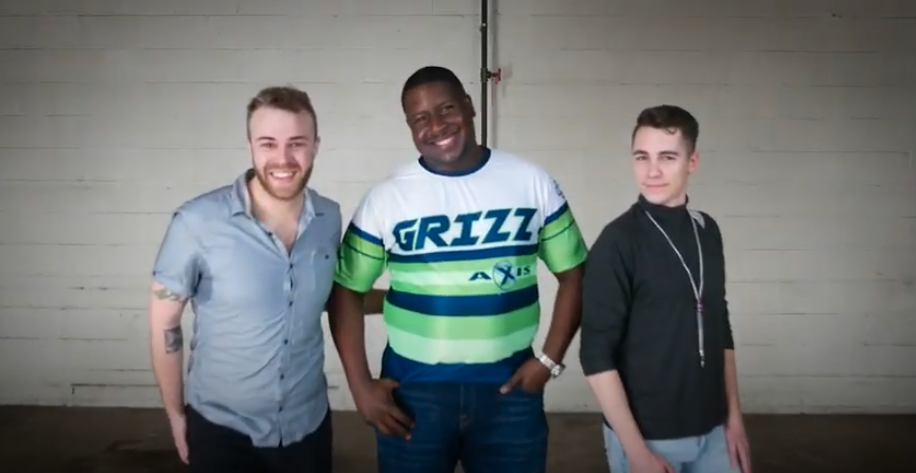 three people standing together smiling