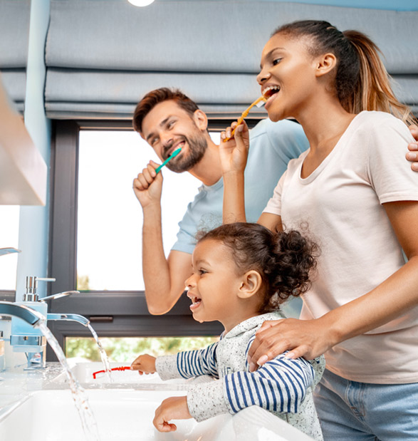 a family practices dental care, teaching their child practical dentistry techniques